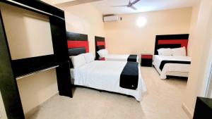 Cama ou camas em um quarto em Hotel Jardín Cancún