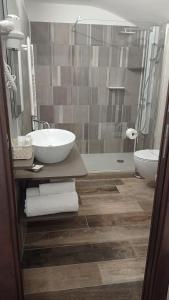 a bathroom with a sink and a toilet and a shower at Hotel Ristorante Caligiuri in Decollatura +27 photos
