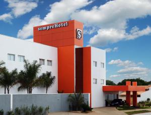 a building with a sign for a hotel at sempreHotel in Três Lagoas