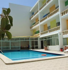 a swimming pool in front of a building at NSTS Campus Residence and Hostel in Msida