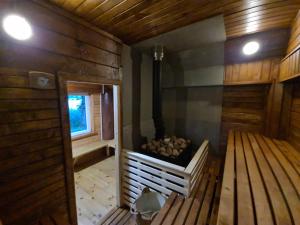 an inside view of a sauna with wood walls at Rubikių Meldynas Anykščiai in Anykščiai