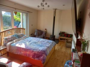 een slaapkamer met een bed en een groot raam bij No 9 Manor Way in Carmarthen