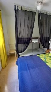 A bed or beds in a room at Ático Roquetas