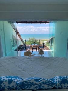 a room with a view of the ocean from a house at Casa Alto do Cunhau in Barra do Cunhau