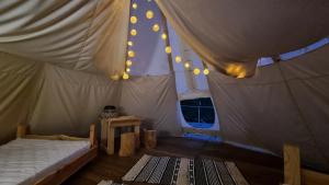a bedroom with a bed in a tent at Tipi Bieszczady Puchary in Hoczew
