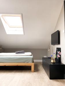 a bedroom with a bed and a skylight at B&Bie ons in Bad-Nieuweschans +20 photos