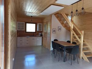 a kitchen and dining room with a table and chairs at Podkarpacka Chata in Iwonicz-Zdrój