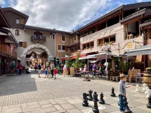 a young boy playing chess in a city street at Ruim en modern appartement super centraal gelegen aan de piste in Valmorel +16 photos