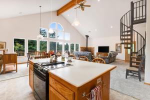a kitchen and living room with a stove at Huckleberry Haven in Tillamook