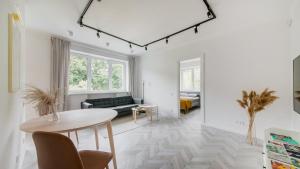 a living room with a table and a couch at Central Apartment in Architectural Street in Kaunas
