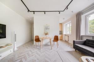a living room with a table and chairs and a couch at Central Apartment in Architectural Street in Kaunas