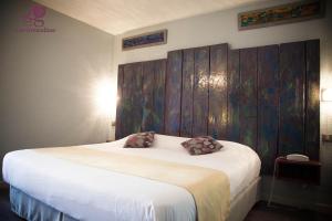 Postel nebo postele na pokoji v ubytování Hotel Les Grenadines