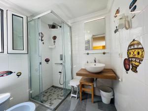 a bathroom with a glass shower and a sink at La Palladiana - Immobilevante in Ponza +42 photos