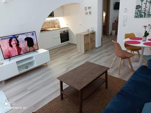 a living room with a couch and a tv and a table at A Casa di Fede in Capurso