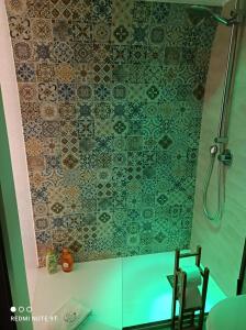 a shower with a glass door next to a chair at A Casa di Fede in Capurso
