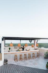 an outdoor bar on the roof of a building at Xkeban Tulum Adults Only in Tulum