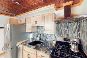 a kitchen with wooden cabinets and a stove top oven at Grand Avenue Retreat in Bozeman