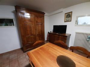 a dining room with a wooden table and a television at La casa di Walter e Rosa in Castel di Sangro