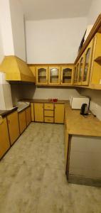 an empty kitchen with wooden cabinets and a counter at Stairway to Heaven in Murree