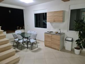 a kitchen and dining room with a table and chairs at Lida apartments in Ulcinj