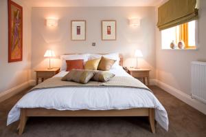 a bedroom with a large bed with two lamps at Hay Retreats in Hay-on-Wye