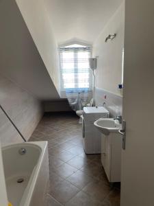 a bathroom with a sink and a toilet and a window at Casa vacanze open space in Carrao