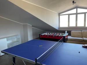 a living room with a ping pong table and a couch at Casa vacanze open space in Carrao