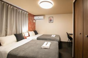 a hotel room with two beds and a desk at Bright Hotel Kiyomizu - Vacation STAY 71447v in Gionmachi