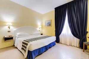 a bedroom with a bed and a large window at Best Western Hotel La Solara in Sorrento