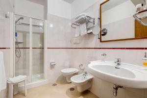 a bathroom with a sink and a toilet and a shower at Best Western Hotel La Solara in Sorrento
