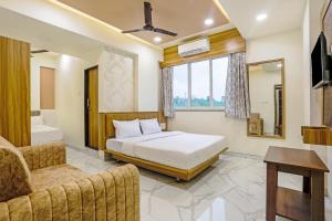 a bedroom with a bed and a bath room at Sai Sagar Lodging & Boarding in Ulhasnagar