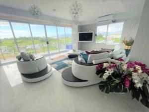 a large living room with couches and flowers on the floor at AYDIZ APARTMENTS in Nadi