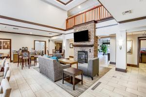 a living room with furniture and a fireplace at Staybridge Suites Gulf Shores, an IHG Hotel in Gulf Shores