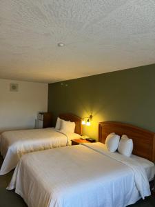 Voodi või voodid majutusasutuse The Grand Hotel Nanaimo toas