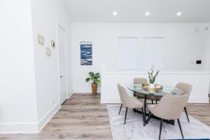 a dining room with a glass table and chairs at Downtown Houston Modern Home in Houston