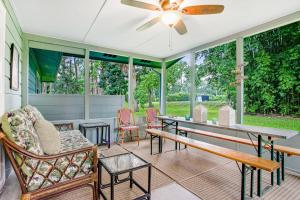 a screened in porch with a table and chairs at 96097 Piney Island in Fernandina Beach