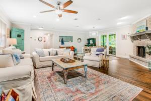 a living room with white furniture and a fireplace at 96097 Piney Island in Fernandina Beach