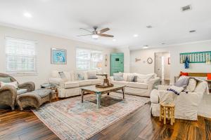 a living room with white furniture and a ceiling fan at 96097 Piney Island in Fernandina Beach