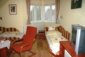 a room with two beds and a table and chairs at Ludas Fogadó in Nagyalásony