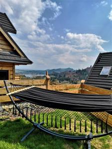 a hammock sitting on the grass next to a house at Chill and Rest Apartments in Falsztyn