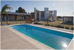 a blue swimming pool in front of a house at Las Mentas in Victoria