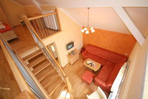 an overhead view of a living room with a couch and stairs at Pichlhof Apartments - Comfort Near Planai in Schladming