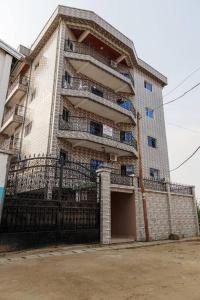 a tall building with a gate in front of it at Beautiful- 1 Bedroom Apartment - Parking on site in Douala