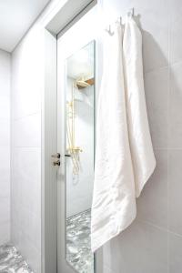 a bathroom with white towels hanging on a mirror at New Family Penthouse 7Min from Rotterdam Central Station top floor app4 in Schiedam