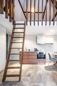 a kitchen with a wooden staircase in a loft at New Family Penthouse 7Min from Rotterdam Central Station top floor app4 in Schiedam
