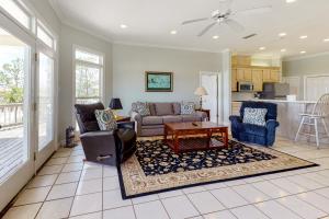 a living room with a couch and a table at Sunny Side Up in Dauphin Island