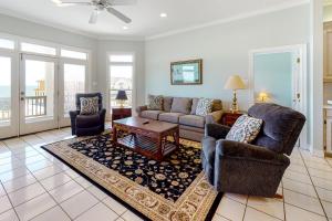 a living room with a couch and a table at Sunny Side Up in Dauphin Island