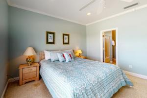 a bedroom with a bed and a table with a lamp at Sunny Side Up in Dauphin Island