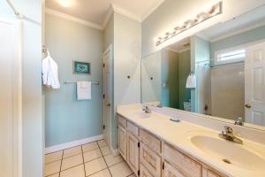 a bathroom with a sink and a mirror at Sunny Side Up in Dauphin Island +20 photos