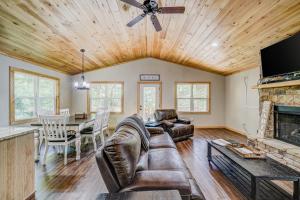a living room with a couch and a fireplace at Cozy Cabin in Ellijay